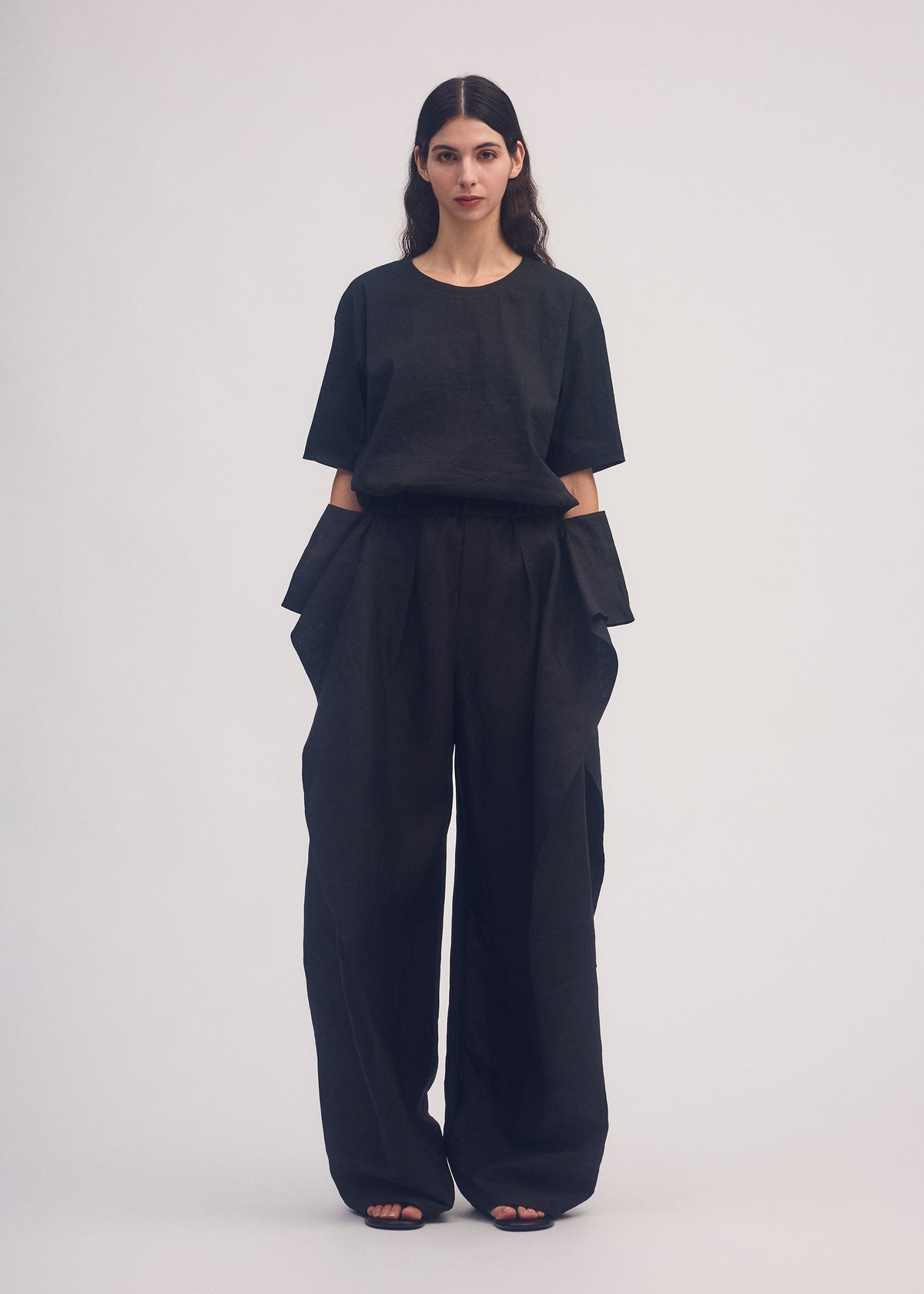 A model wears the ISSEY MIYAKE HEMPEN trousers.