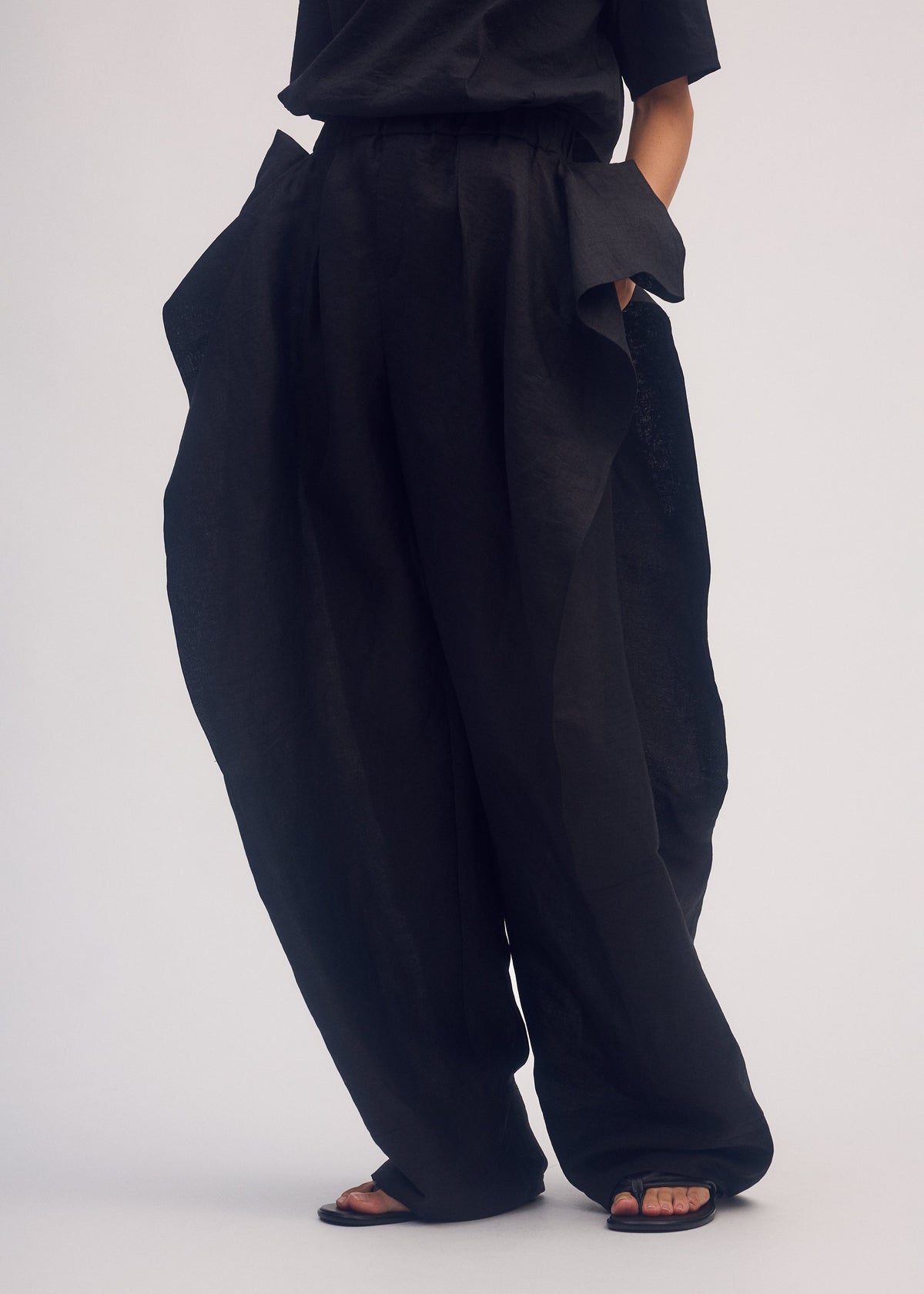 A model wears the ISSEY MIYAKE HEMPEN trousers.