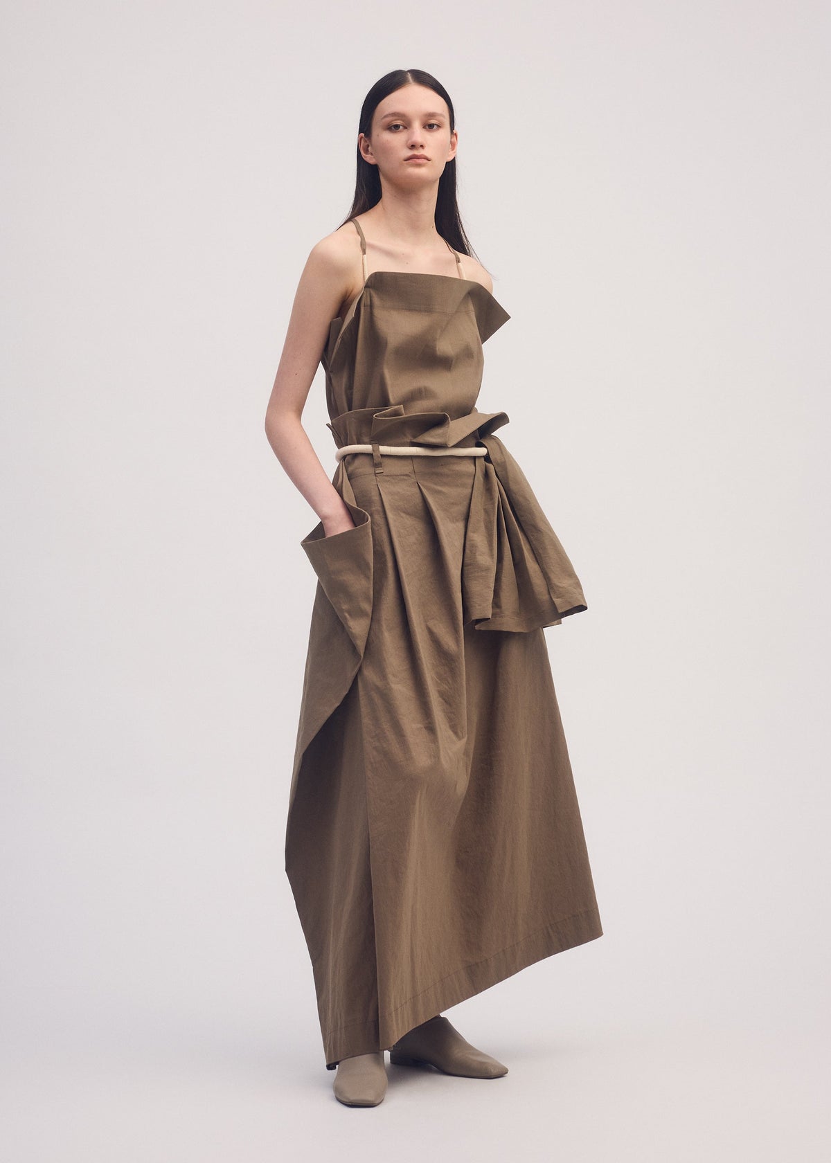 A model wears the ISSEY MIYAKE CLOTH AND CORD skirt.