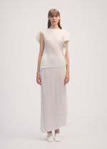 A model wears the ISSEY MIYAKE SHADOW STUDY PLEATS SOLID skirt.