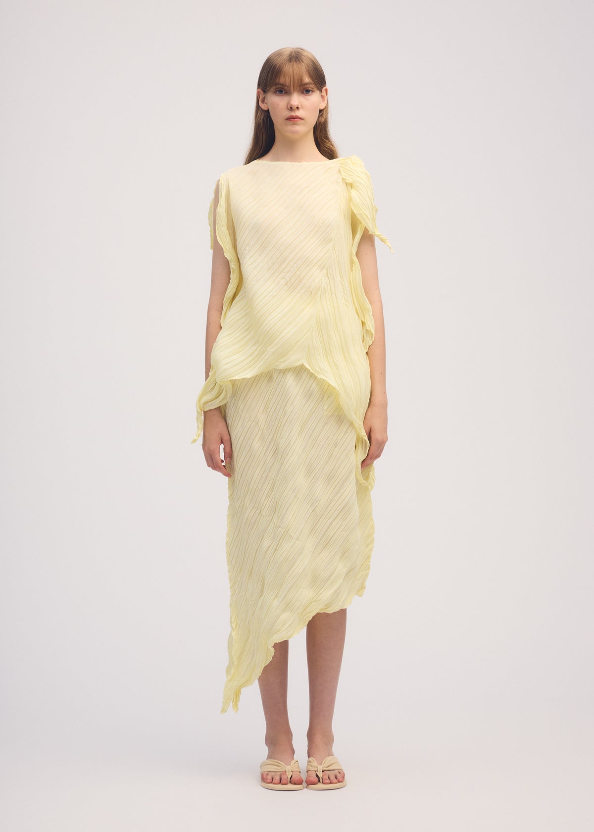 A model wears the ISSEY MIYAKE WRINKLED AND TWISTED skirt.