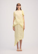 A model wears the ISSEY MIYAKE WRINKLED AND TWISTED skirt.