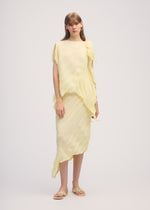 A model wears the ISSEY MIYAKE WRINKLED AND TWISTED skirt.
