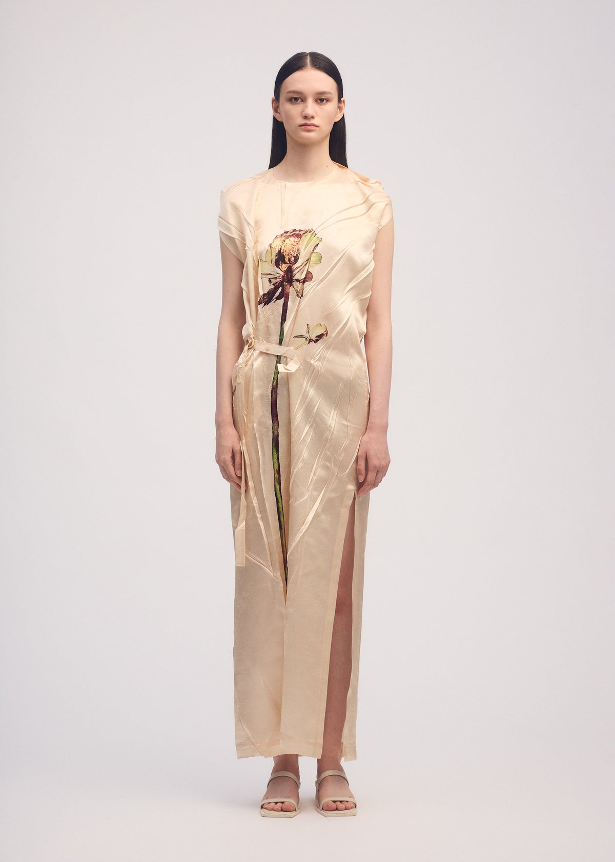 A model wears the ISSEY MIYAKE PRESSED FLORA dress.