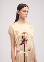 A model wears the ISSEY MIYAKE PRESSED FLORA dress.