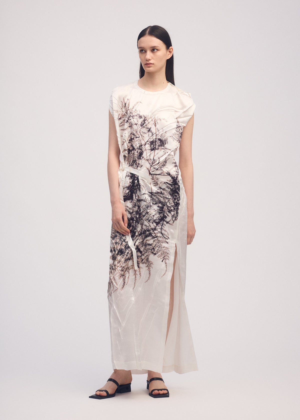 A model wears the ISSEY MIYAKE PRESSED FLORA dress.