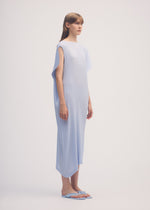 A model wears the ISSEY MIYAKE SHADOW STUDY PLEATS SOLID dress.
