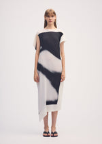 A model wears the ISSEY MIYAKE SHADOW STUDY PLEATS dress.
