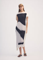 A model wears the ISSEY MIYAKE SHADOW STUDY PLEATS dress.