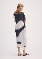 A model wears the ISSEY MIYAKE SHADOW STUDY PLEATS dress.