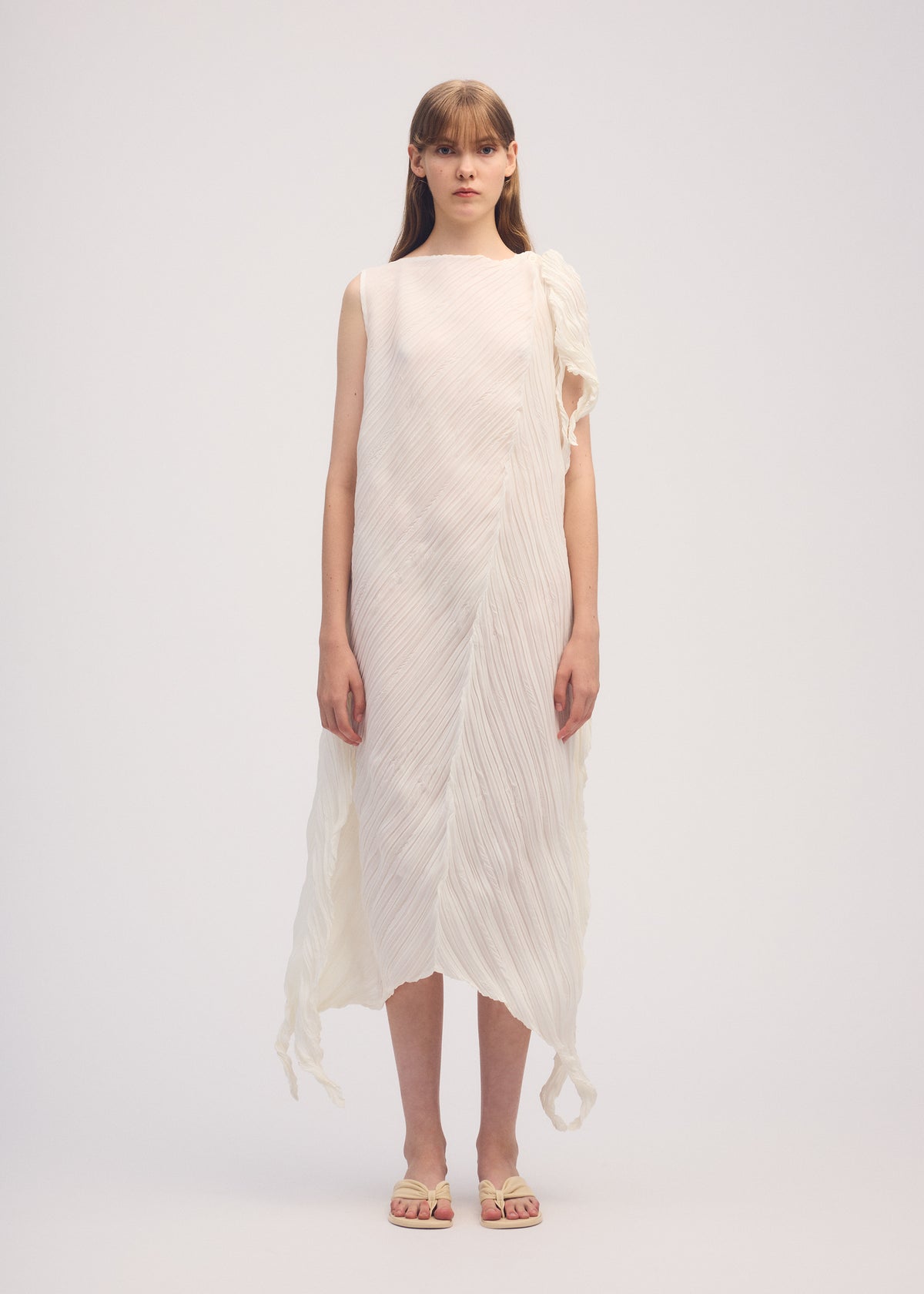 A model wears the ISSEY MIYAKE WRINKLED AND TWISTED dress.