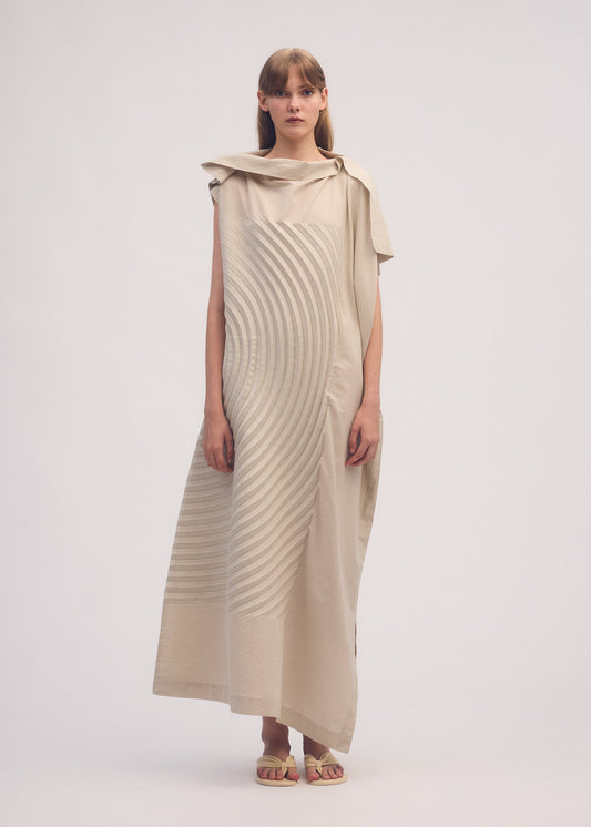 A model wears the ISSEY MIYAKE FLOW dress.