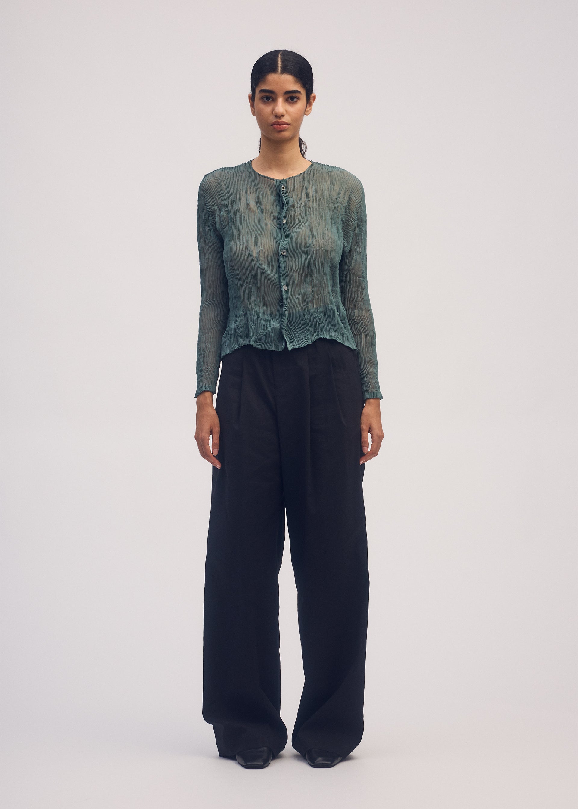 A model wears the ISSEY MIYAKE CHIFFON TWIST 1 shirt.