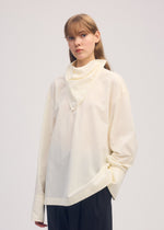 A model wears the ISSEY MIYAKE COTTON VOILE SHIRT shirt.