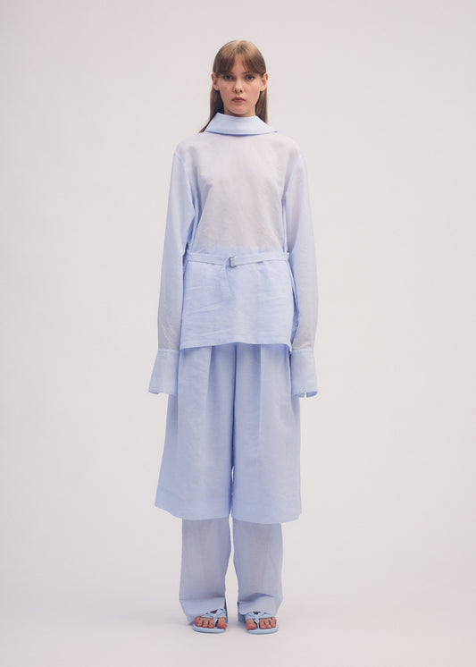 A model wears the ISSEY MIYAKE PAPER ESQUE U shirt.