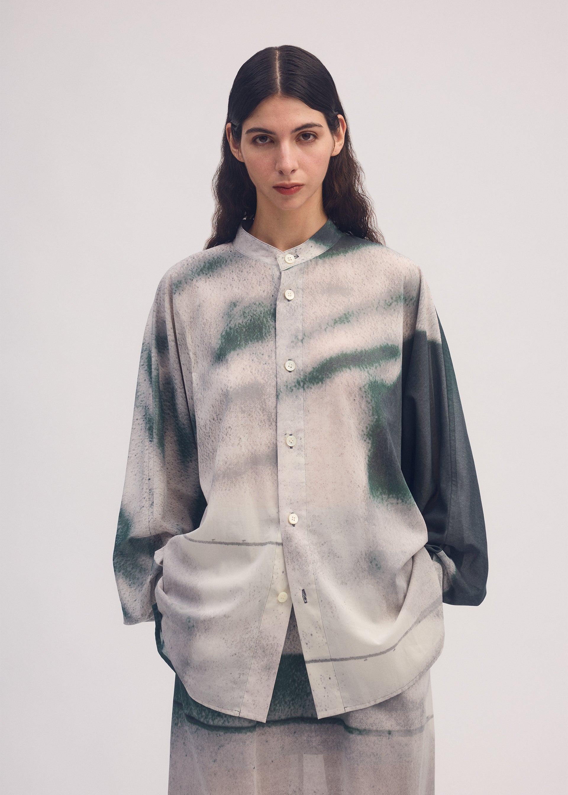 A model wears the ISSEY MIYAKE SHADOW STUDY shirt.