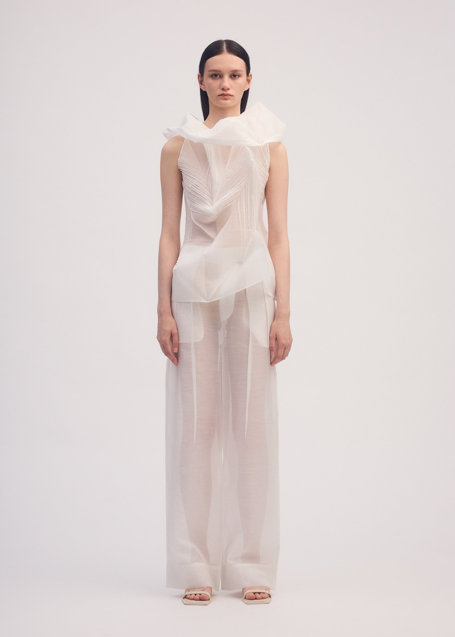 A model wears the ISSEY MIYAKE SHADE AND SHADED shirt.
