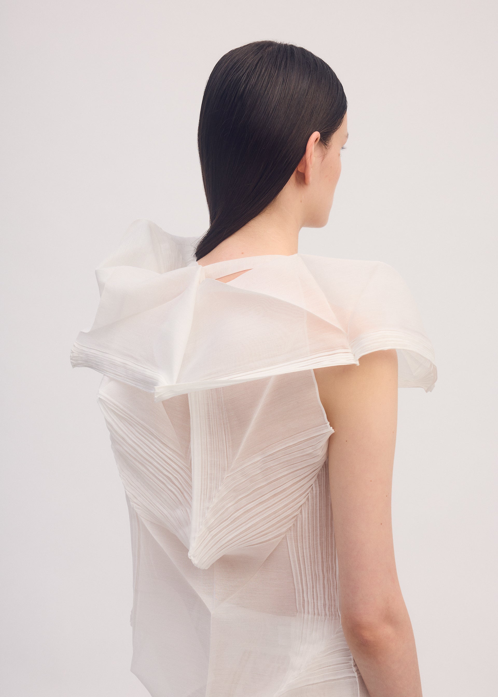 A model wears the ISSEY MIYAKE SHADE AND SHADED shirt.