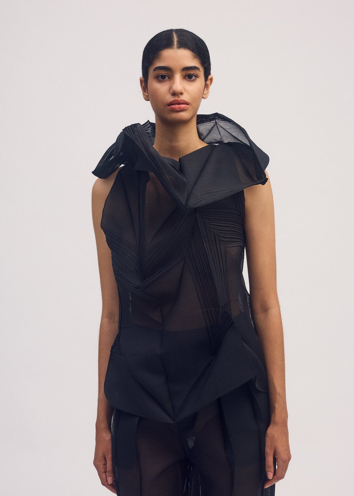 A model wears the ISSEY MIYAKE SHADE AND SHADED shirt.