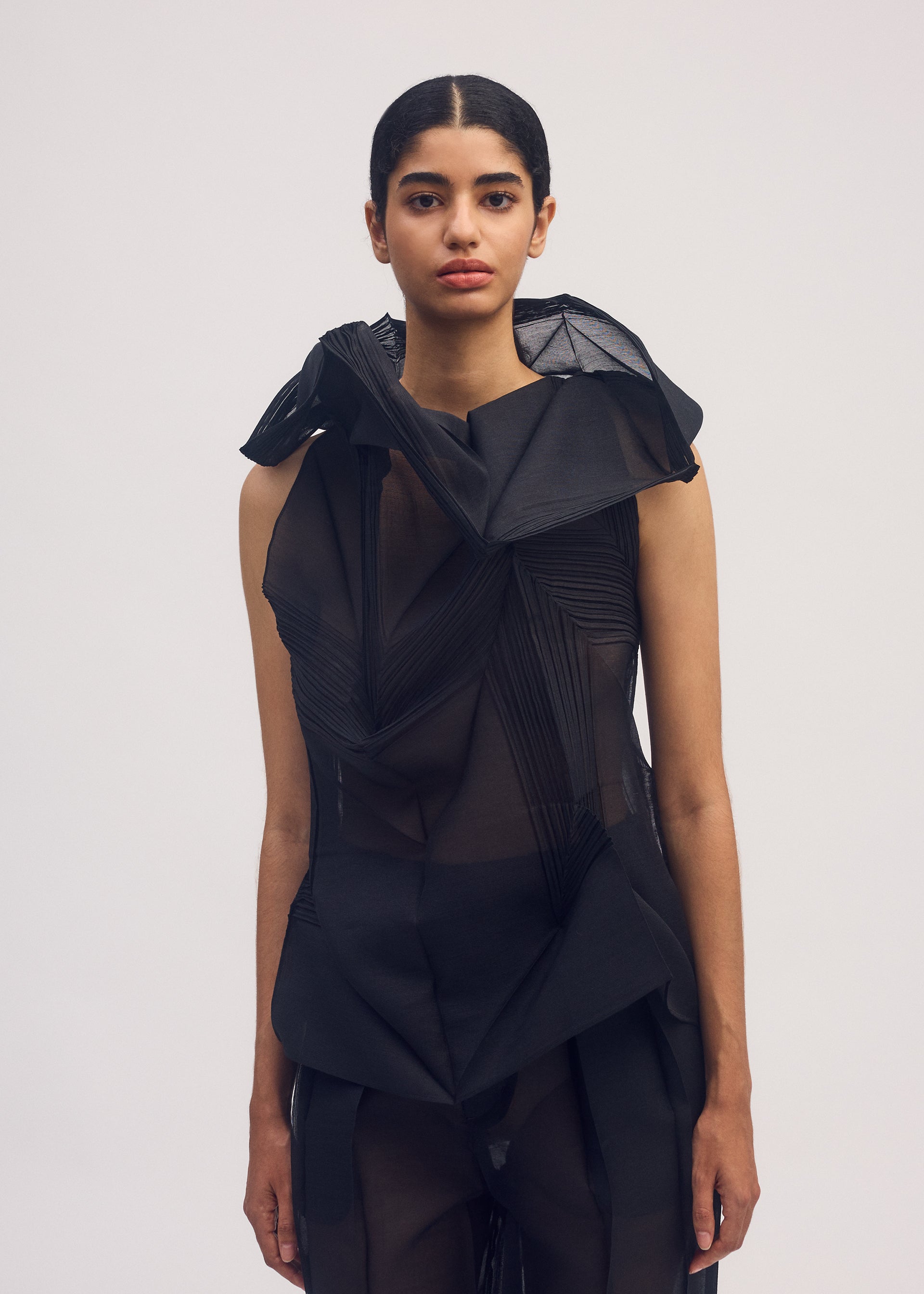 A model wears the ISSEY MIYAKE SHADE AND SHADED shirt.