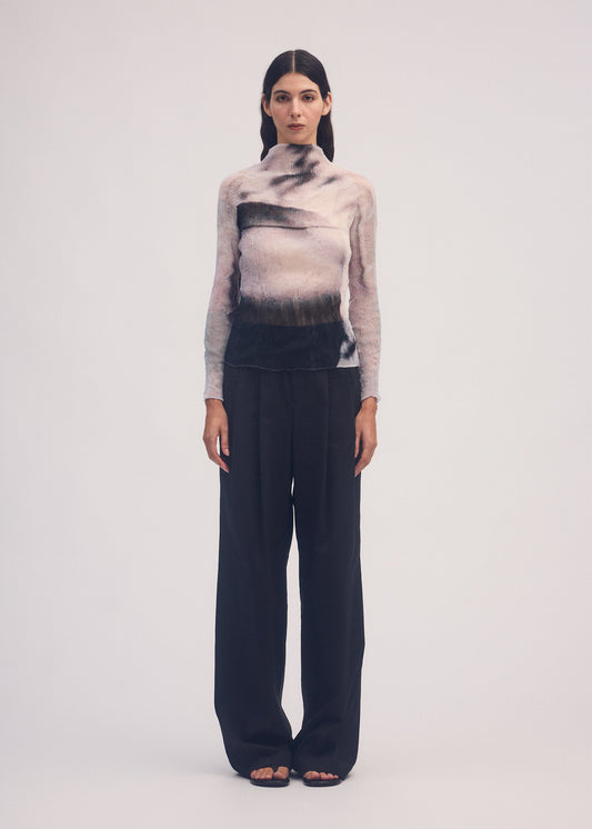 A model wears the ISSEY MIYAKE SHADOW STUDY CHIFFON TWIST shirt.