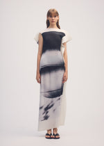 A model wears the ISSEY MIYAKE SHADOW STUDY PLEATS shirt.