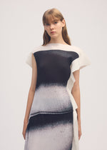 A model wears the ISSEY MIYAKE SHADOW STUDY PLEATS shirt.