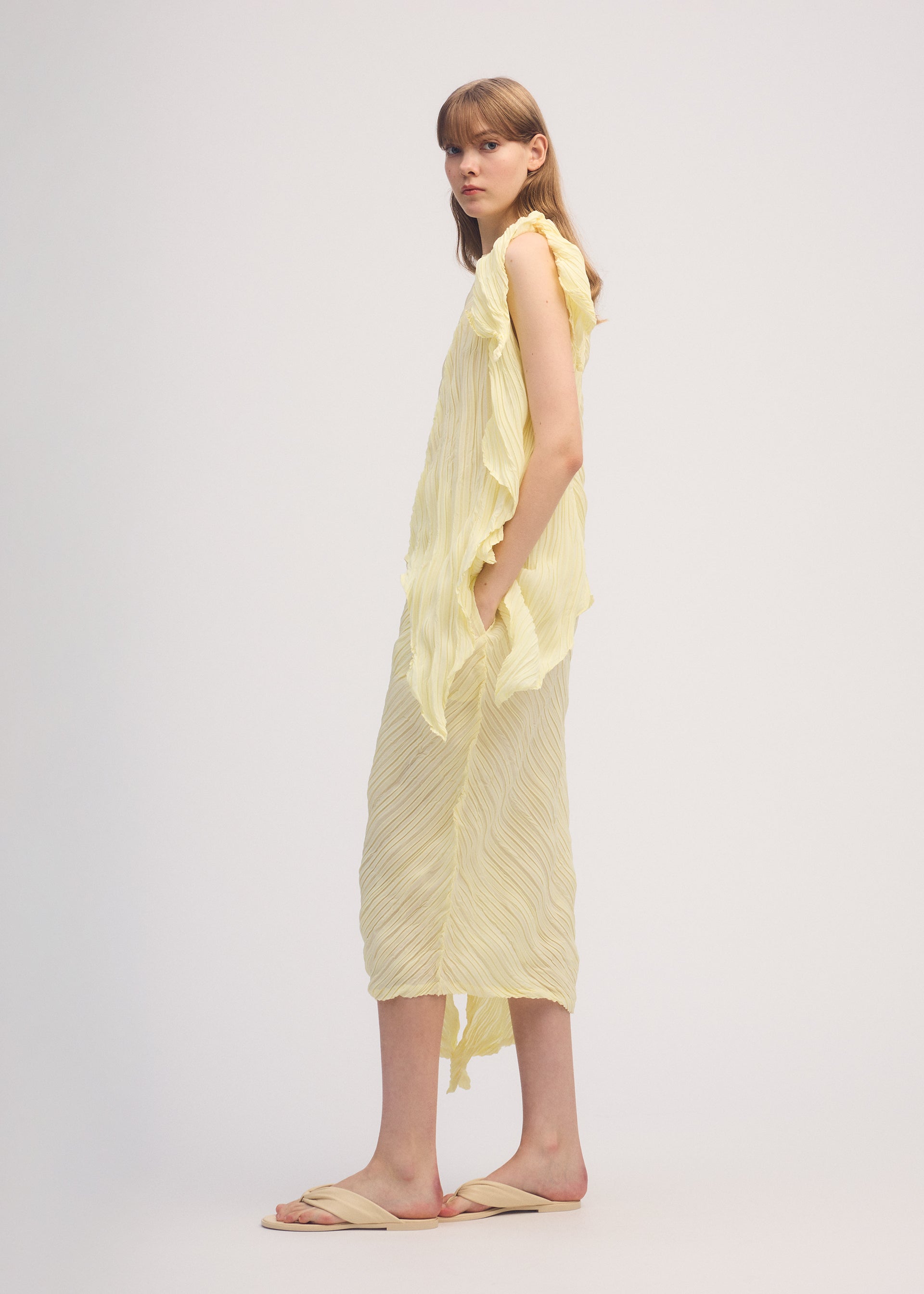 A model wears the ISSEY MIYAKE WRINKLED AND TWISTED shirt.