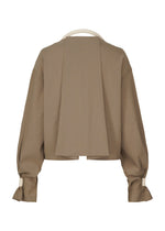 A detail shot of the ISSEY MIYAKE CLOTH AND CORD cardigan.