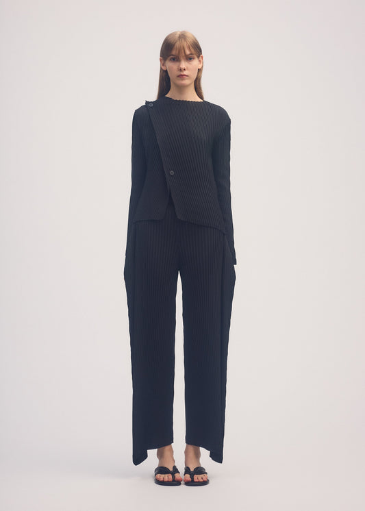 A model wears the ISSEY MIYAKE SHADOW STUDY PLEATS SOLID cardigan.
