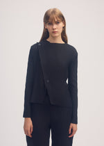A model wears the ISSEY MIYAKE SHADOW STUDY PLEATS SOLID cardigan.