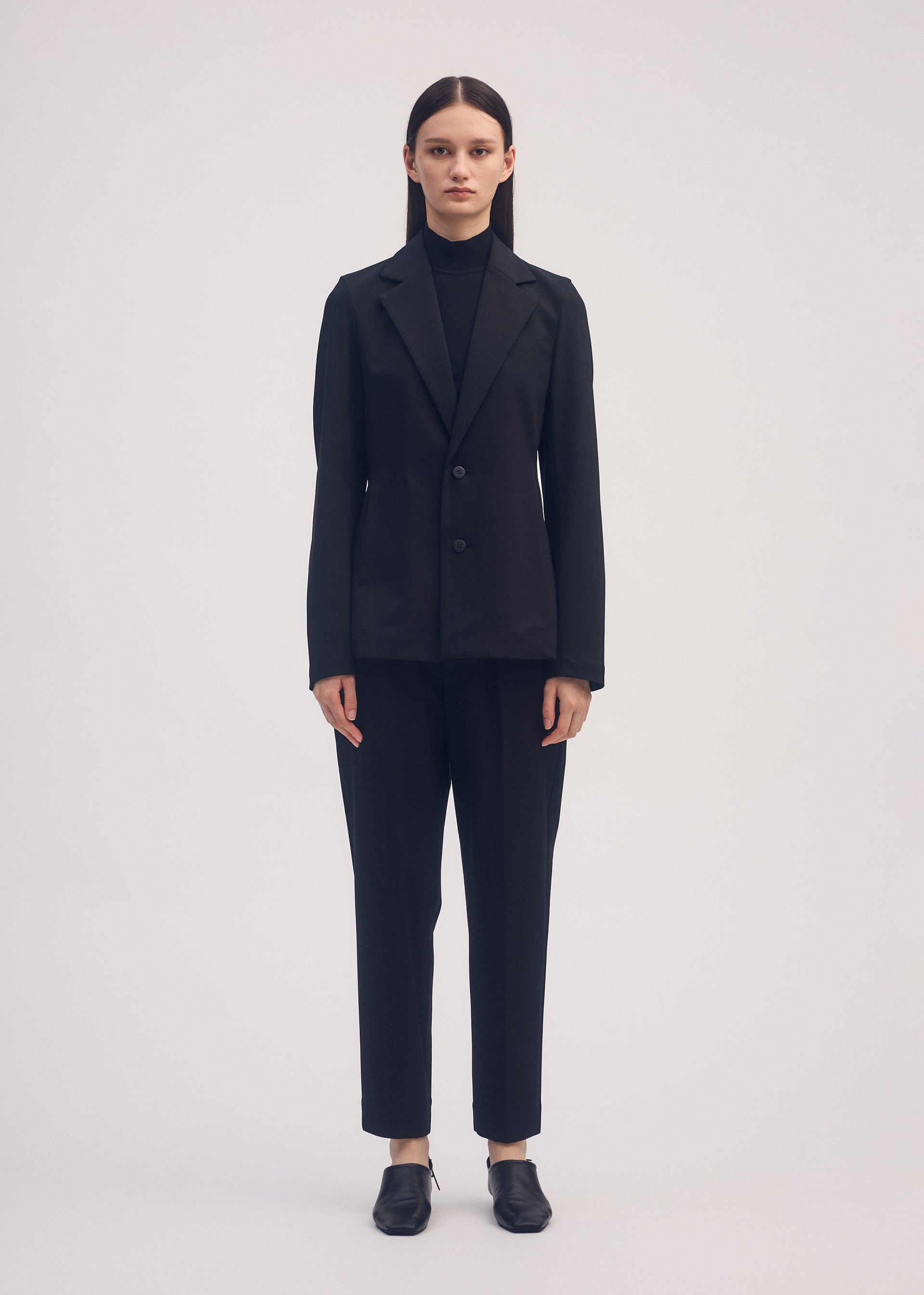 A model wears the ISSEY MIYAKE SIMPLE ENSEMBLE jacket.