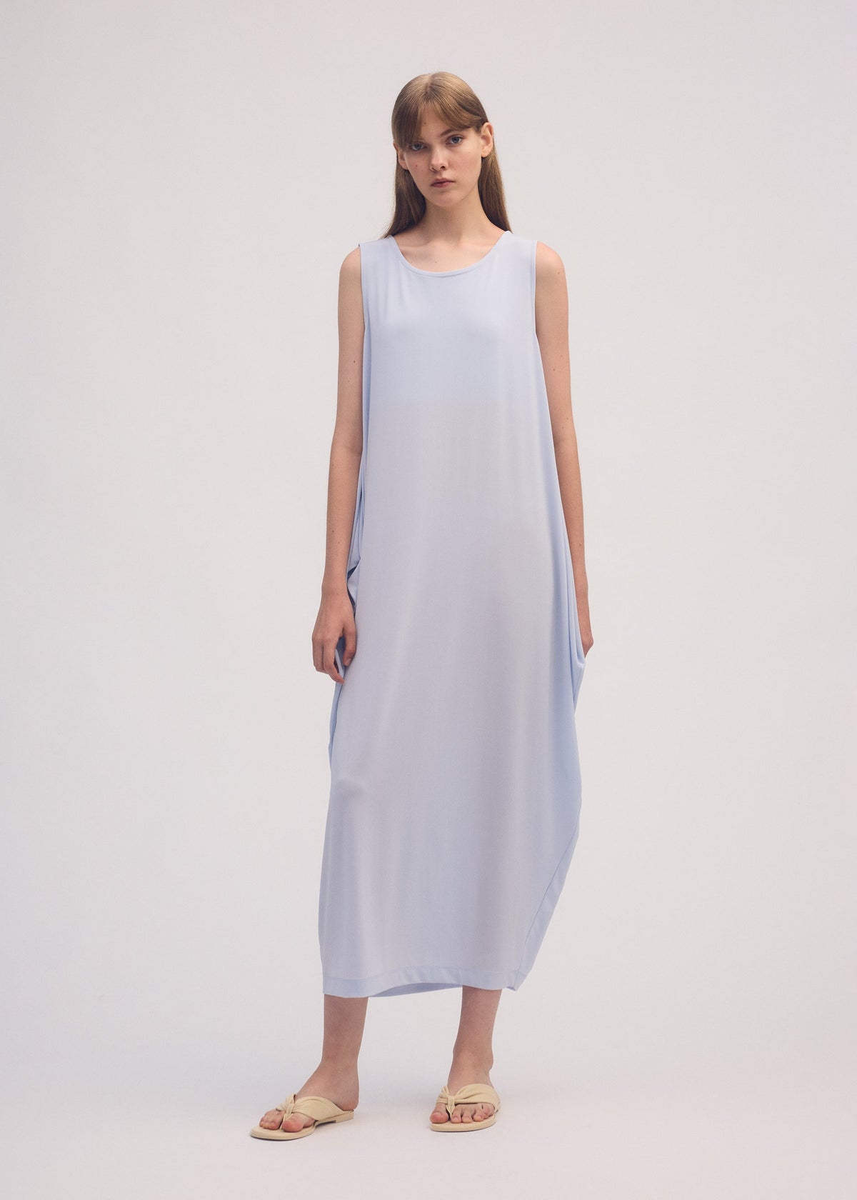 A model wears the ISSEY MIYAKE DRAPE JERSEY 56 dress.