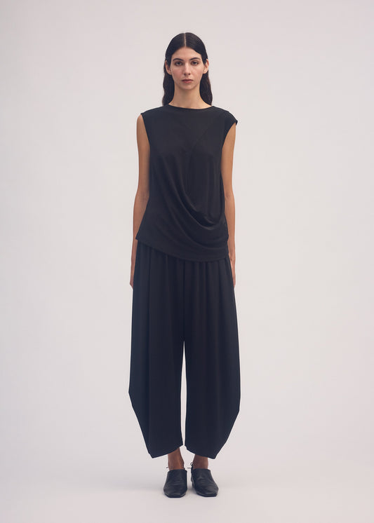 A model wears the ISSEY MIYAKE DRAPE JERSEY 56 top.