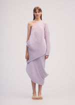 A model wears the ISSEY MIYAKE STREAM skirt.