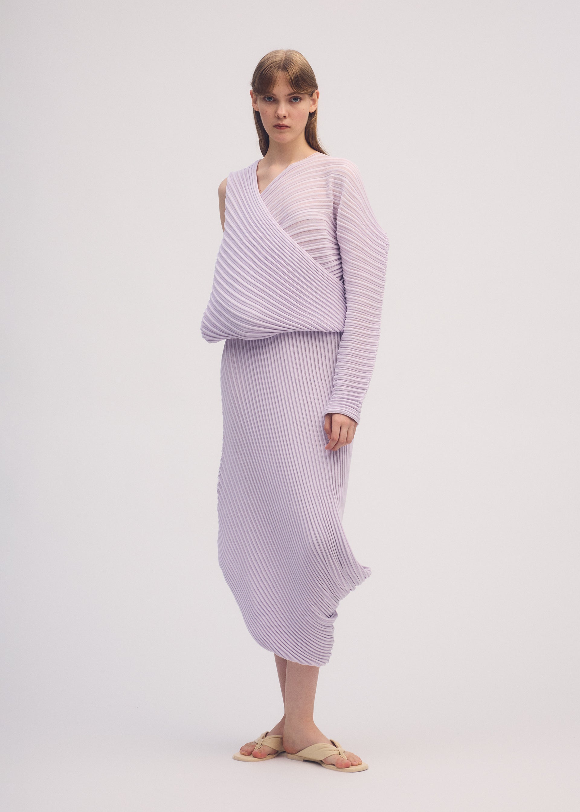 A model wears the ISSEY MIYAKE STREAM skirt.