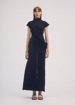 A model wears the ISSEY MIYAKE STREAM dress.