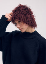 A model wears the ISSEY MIYAKE ODD BEANIE hat.