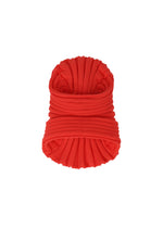A product shot of the ISSEY MIYAKE KNIT (AS IT IS) ACC hat in red.
