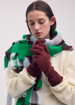 A model wears the ISSEY MIYAKE BREEZE KNIT GLOVES gloves.