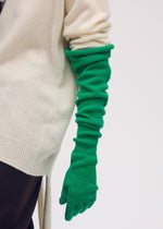 A model wears the ISSEY MIYAKE BREEZE KNIT GLOVES gloves.