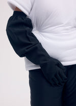 A model wears the ISSEY MIYAKE ODD GLOVES gloves.