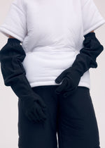 A model wears the ISSEY MIYAKE ODD GLOVES gloves.