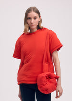 A model wears the ISSEY MIYAKE PUMPED BAG bag.