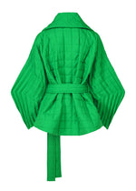 A detail shot of the ISSEY MIYAKE PLEATED GRID coat.