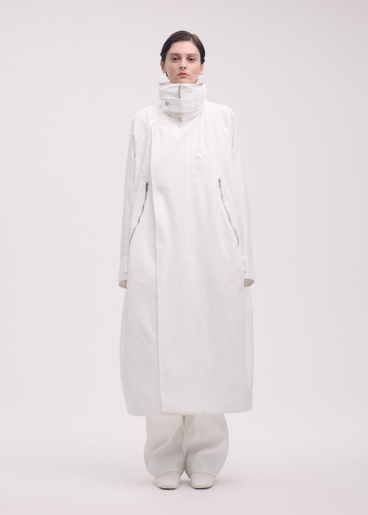 A model wears the ISSEY MIYAKE PEEKABOO coat.