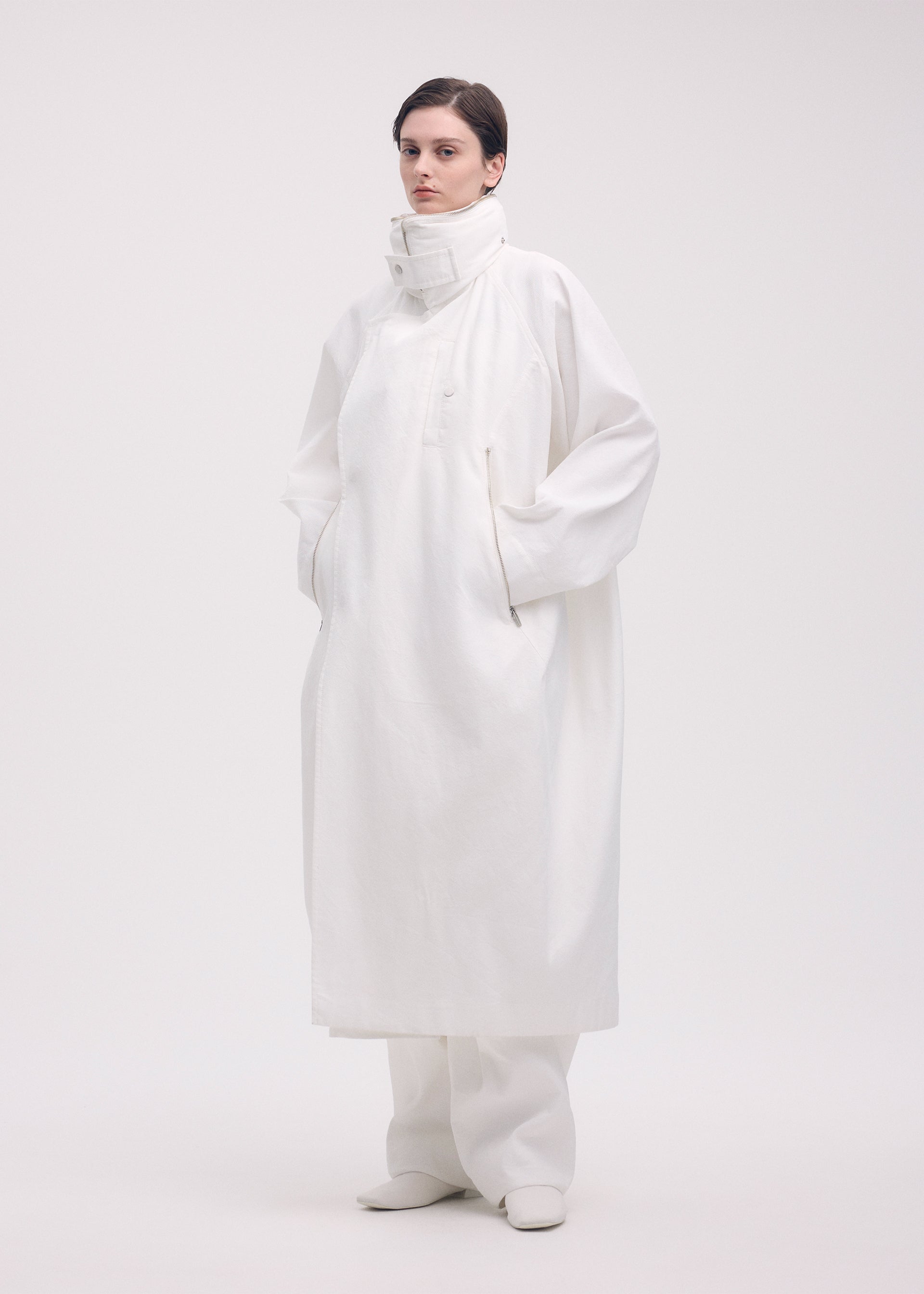 A model wears the ISSEY MIYAKE PEEKABOO coat.