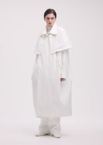 A model wears the ISSEY MIYAKE PEEKABOO coat.