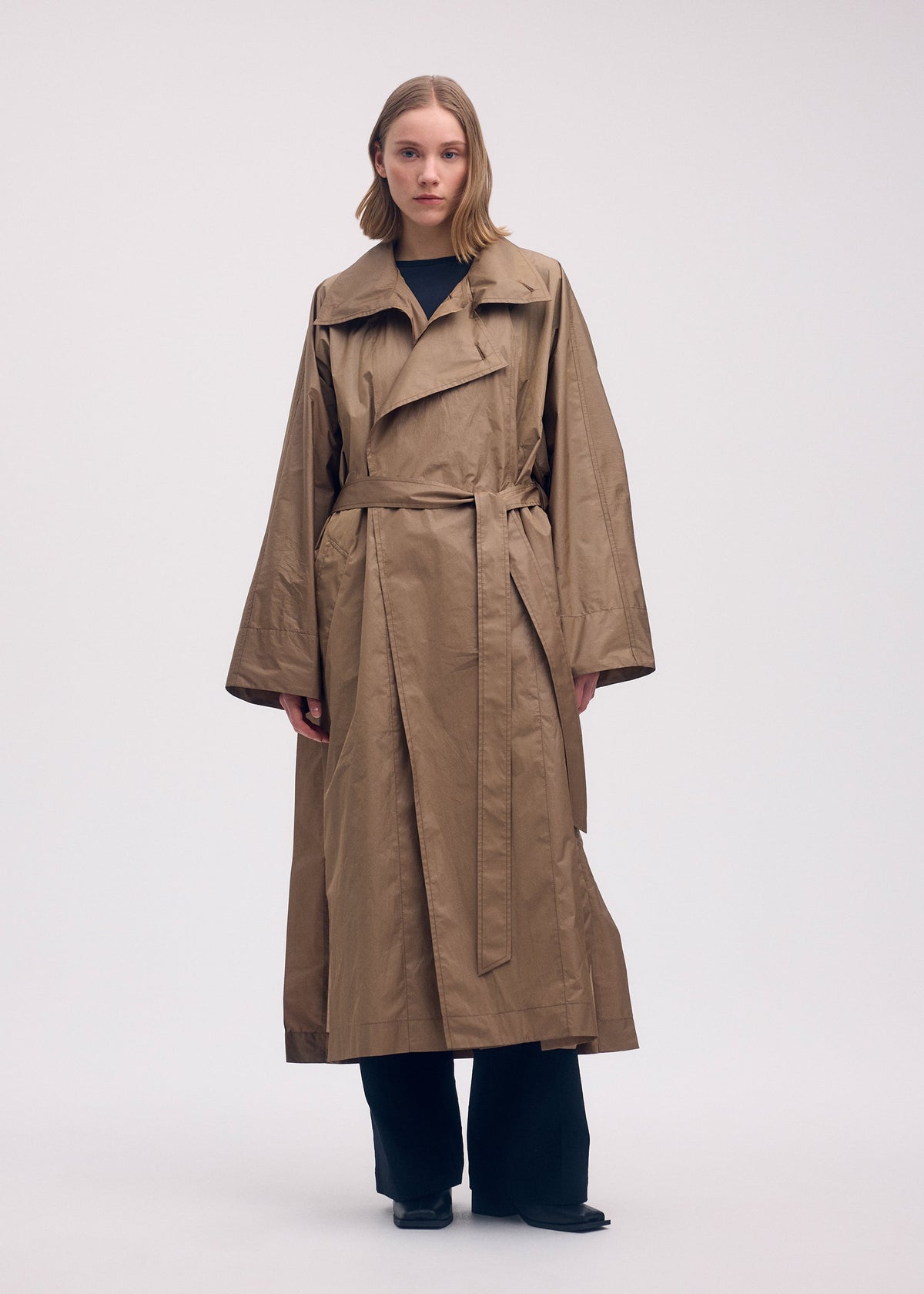 A model wears the ISSEY MIYAKE AERIAL STEEL clothing.