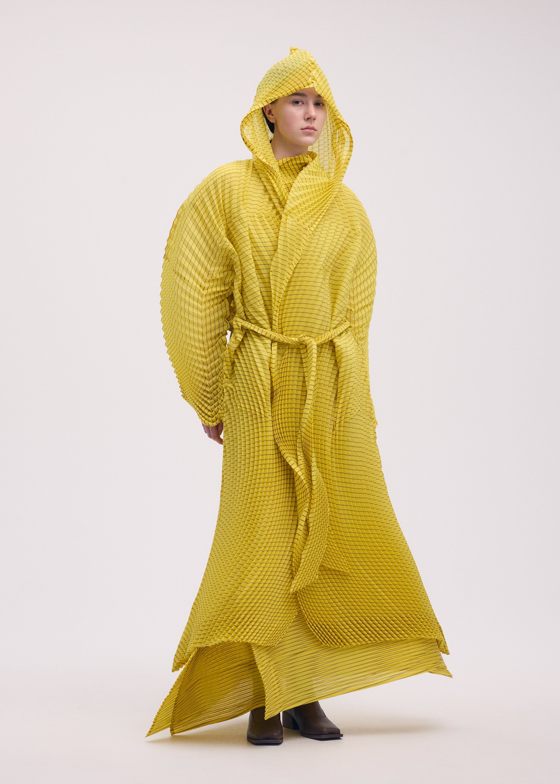 A model wears the ISSEY MIYAKE GENERIC STRIPES (HAND PLEATS) clothing.